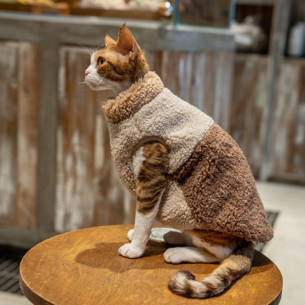 Close-up of the soft, thickened lamb wool fabric and delicate stitching of the cat fleece vest